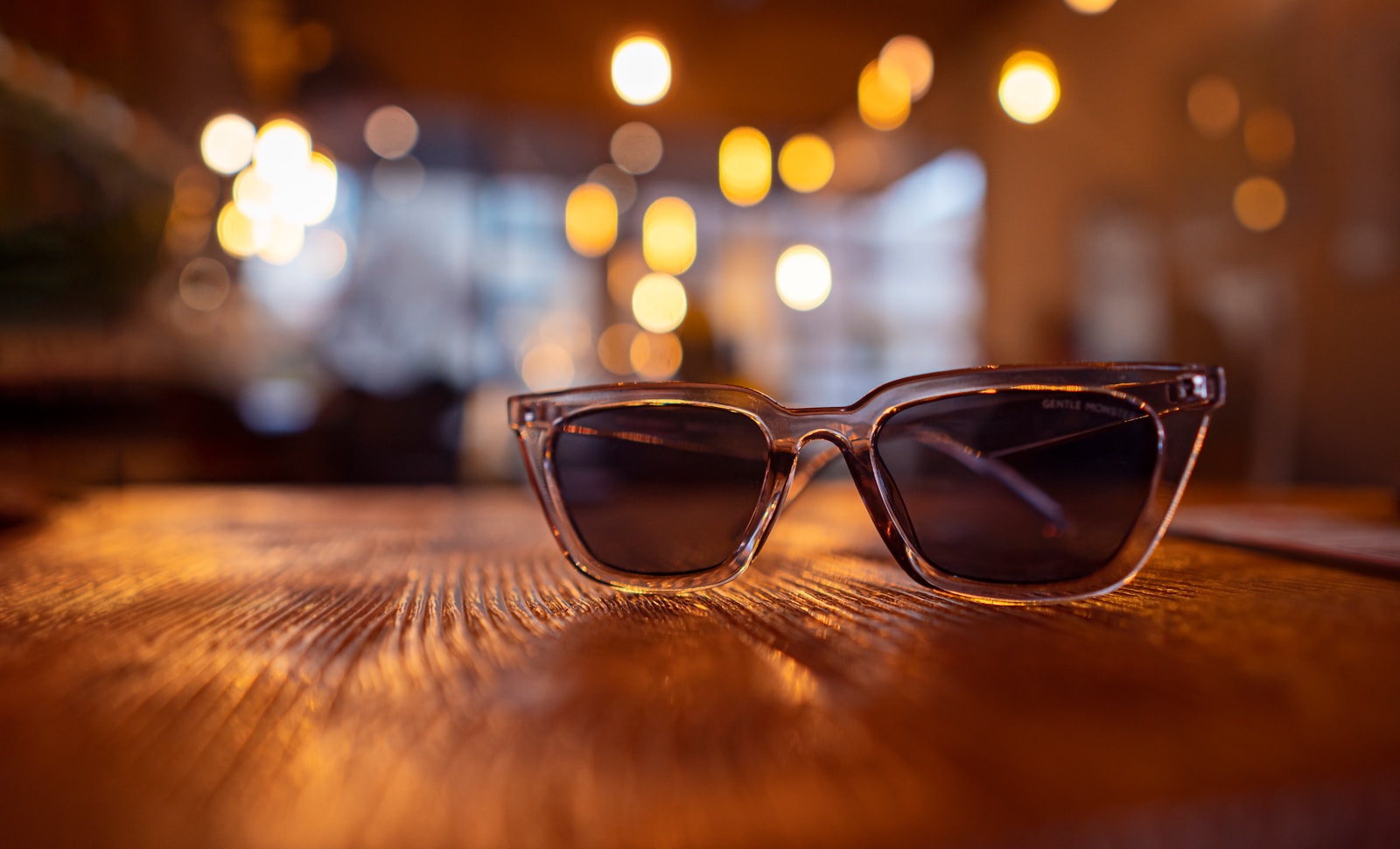 a pair of sunglasses sitting on top of a wooden table